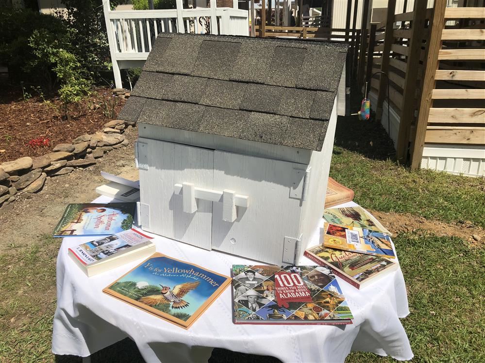 Little Library. Small white box with books around it.