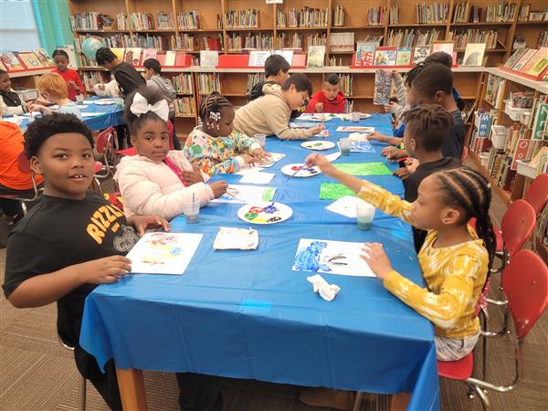 Emerging Super Leaders are enjoying a cookie and painting party for meeting their 3rd Nine Week Accelerated Reading Goals! Showing Unity, these 3rd and 4th grade students work together.