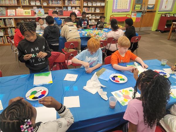 Emerging Super Leaders are enjoying a cookie and painting party for meeting their 3rd Nine Week Accelerated Reading Goals! Showing Unity, these 3rd and 4th grade students work together.